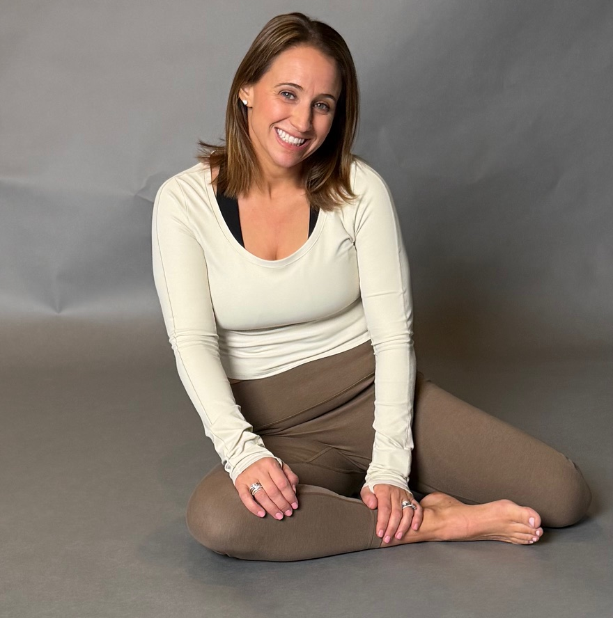 Angela seated and smiling - Sustainable wellness practice
